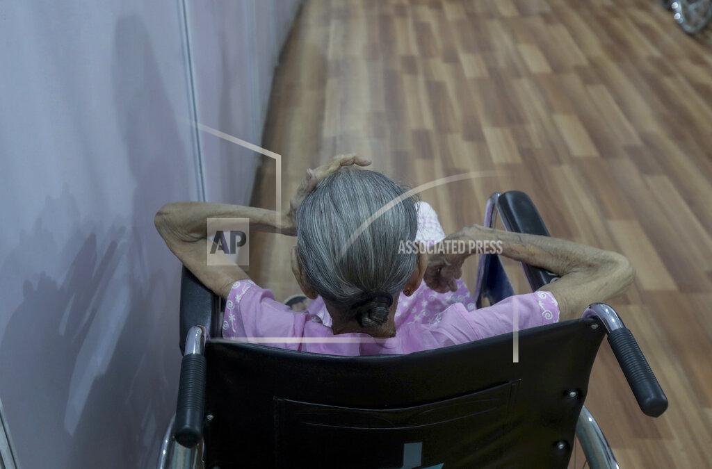 Rafiq Maqbool An elderly woman waits to receive vaccine for COVID-19 at a vaccination center in Mumbai, India, Sunday, April 18, 2021. Over 200,000 new infections were detected in the past 24 hours, and major cities, like Mumbai and New Delhi, are under virus restrictions. (AP Photo/Rafiq Maqbool)