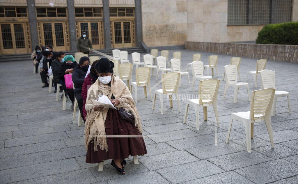 Juan Karita People wait their turn for a shot of the Sinopharm COVID-19 vaccine inside the Universidad Mayor de San Andres public university during vaccinations for people over age 50 in La Paz, Bolivia, Monday, May 17, 2021. (AP Photo/Juan Karita)