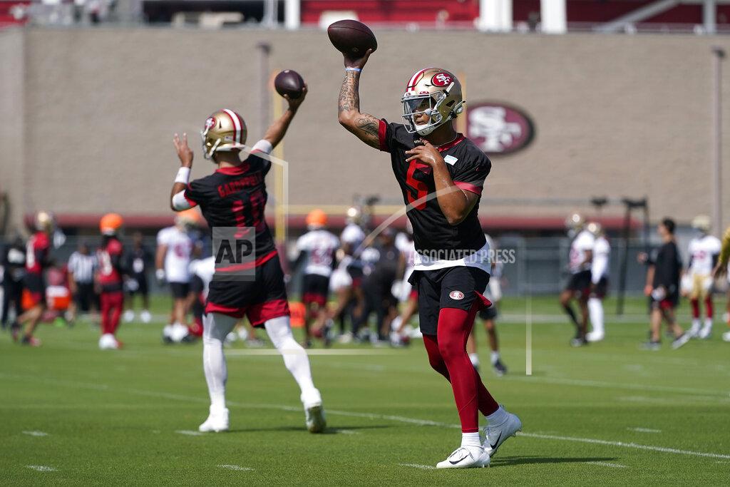 Jeff Chiu San Francisco 49ers quarterbacks Trey Lance (5) and Jimmy Garoppolo (10) throw passes at NFL football training camp in Santa Clara, Calif., Wednesday, July 28, 2021. (AP Photo/Jeff Chiu)