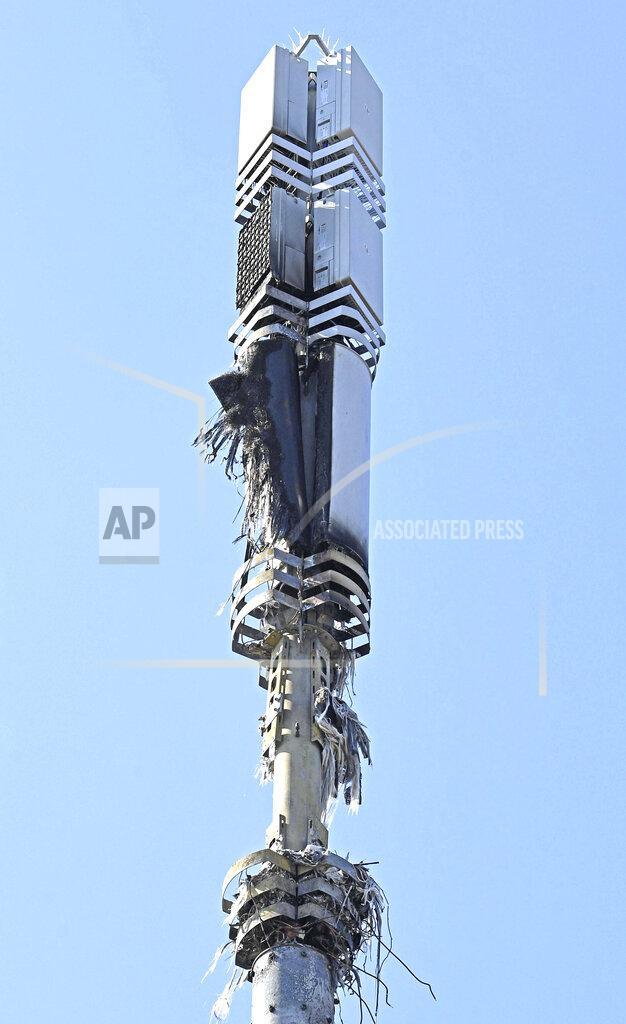 Stefan Rousseau In this Tuesday, April 14, 2020 photo, a view of a cell tower after a fire, in Dagenham, England. Dozens of European cell towers have been destroyed in recent arson attacks that officials and wireless companies say are fueled by groundless conspiracy theories linking new 5G mobile networks and the coronavirus pandemic. (Stefan Rousseau/PA via AP)