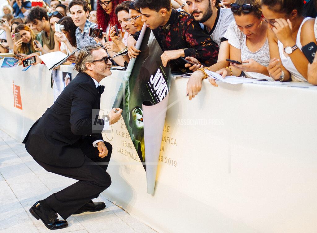 Arthur Mola File - Actor Joaquin Phoenix signs autographs upon arrival at the premiere of the film 'Joker' at the Venice Film Festival. The 77th Venice Film Festival will kick off on Wednesday, Sept. 2, 2020, but this year's edition will be unlike any others. Coronavirus restrictions will mean fewer Hollywood stars, no crowds interacting with actors and other virus safeguards will be deployed. (Photo by Arthur Mola/Invision/AP, File)