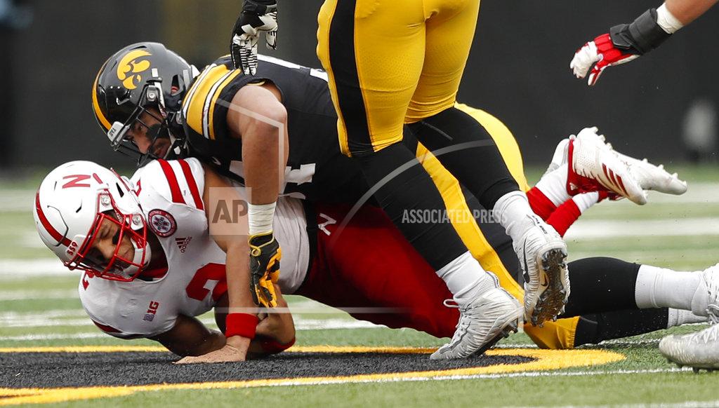 Charlie Neibergall Nebraska quarterback Adrian Martinez (2) is sacked by Iowa defensive end A.J. Epenesa during the first half of an NCAA college football game, Friday, Nov. 23, 2018, in Iowa City, Iowa. (AP Photo/Charlie Neibergall)