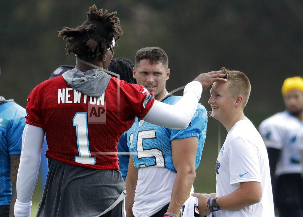 Chuck Burton Carolina Panthers' Cam Newton (1) jokes with a team attendant during practice at the NFL football team's training camp in Spartanburg, N.C., Friday, July 26, 2019. (AP Photo/Chuck Burton)