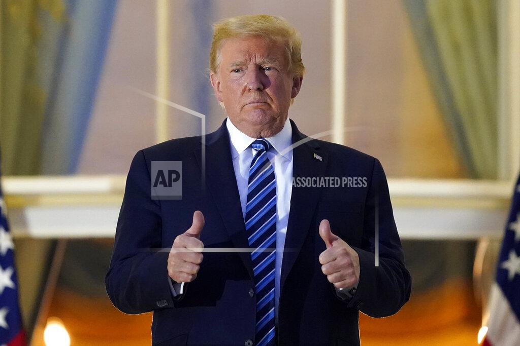 Alex Brandon President Donald Trump stands on the balcony outside of the Blue Room as returns to the White House Monday, Oct. 5, 2020, in Washington, after leaving Walter Reed National Military Medical Center, in Bethesda, Md. Trump announced he tested positive for COVID-19 on Oct. 2. (AP Photo/Alex Brandon)