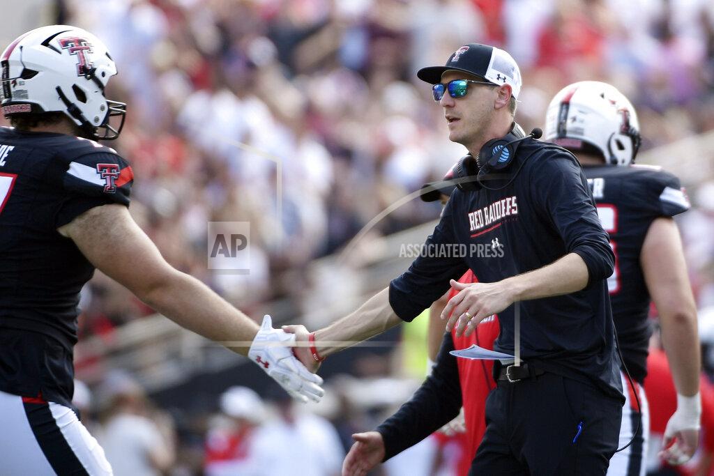 Justin Rex FILE - Texas Tech offensive coordinator Zach Kittley congratulates offensive lineman Ethan Carde after a scoring drive against Houston during the first half of an NCAA college football game on Sept. 10, 2022, in Houston. Kittley is the son of the longtime Texas Tech track coach and NCAA championship winner Wes Kittley. The younger Kittley was always consumed by football growing up. (AP Photo/Justin Rex, File)