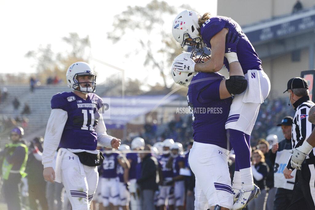 Paul Beaty Northwestern wide receiver Riley Lees (19) celebrates with teammate Nik Urban (66) while quarterback Aidan Smith (11) looks on after Lees caught a touchdown pass during the second half of an NCAA college football game against Purdue Saturday, Nov. 9, 2019, in Evanston, Ill. Purdue won 24-22. (AP Photo/Paul Beaty)