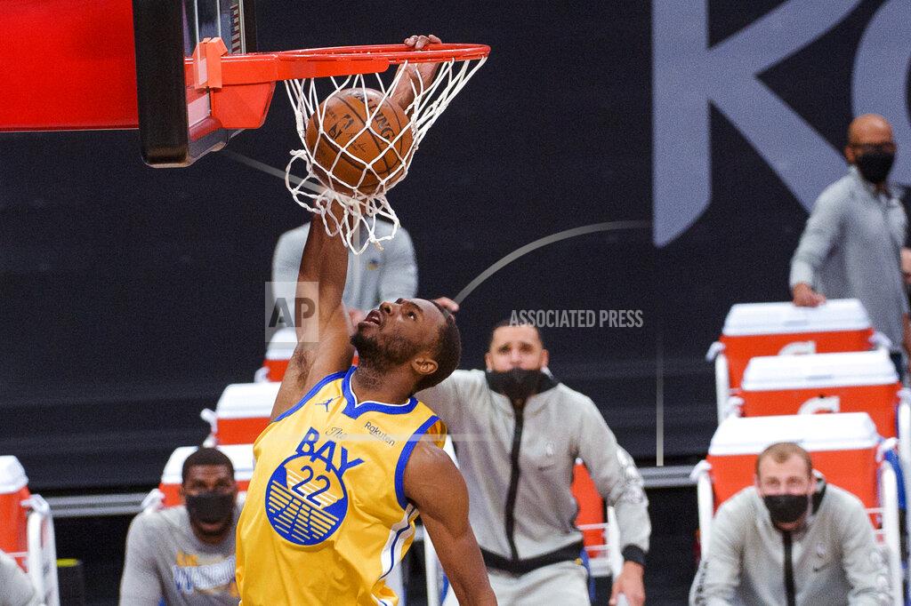 Randall Benton Golden State Warriors forward Andrew Wiggins (22) dunks against the Sacramento Kings during the first quarter of an NBA basketball game in Sacramento, Calif., Thursday, March 25, 2021. (AP Photo/Randall Benton)