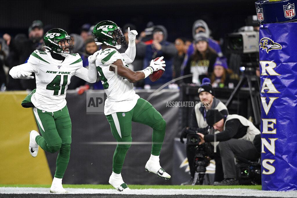 Nick Wass New York Jets linebacker B.J. Bello (49) reacts while returning a Baltimore Ravens blocked punt for a touchdown during the second half of an NFL football game, Thursday, Dec. 12, 2019, in Baltimore. Jets defensive back Matthias Farley (41) joins in the celebration. (AP Photo/Nick Wass)