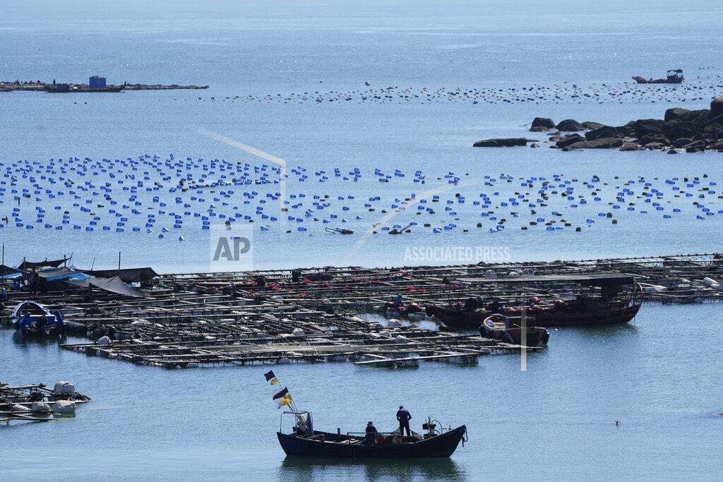 Ng Han Guan A boat moves through the water at the 68-nautical-mile scenic spot, the closest point in mainland China to the island of Taiwan, in Pingtan in southeastern China's Fujian Province, Friday, Aug. 5, 2022. China conducted "precision missile strikes" Thursday in waters off Taiwan's coasts as part of military exercises that have raised tensions in the region to their highest level in decades following a visit by U.S. House Speaker Nancy Pelosi. (AP Photo/Ng Han Guan)