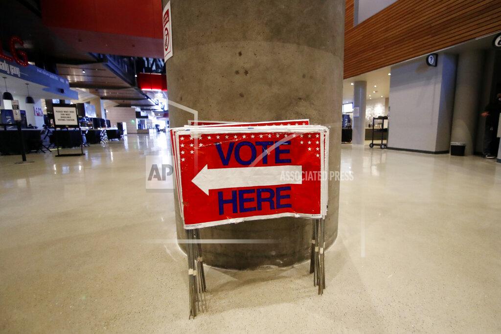 John Bazemore Election signs are stored at State Farm Arena, home of the NBA's Atlanta Hawks basketball team, Friday, July 17, 2020, in Atlanta. The 16,888-seat facility will be used as a poll location for the upcoming election. (AP Photo/John Bazemore)