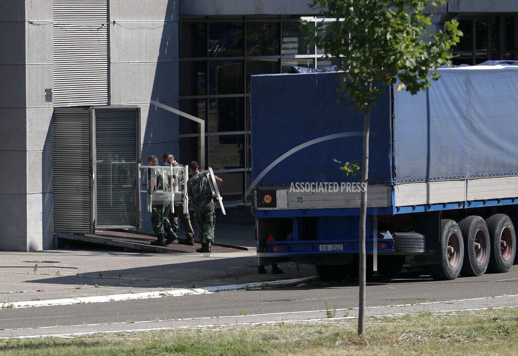 Serbian soldiers set up beds for treatment of possible COVID-19 infected patients inside of the Belgrade Arena, in Belgrade, Serbia, Monday, July 6, 2020. Serbian authorities have declared an emergency in the capital Belgrade because of a surge in the new coronavirus cases. Emergency measures also have been introduced in several other towns in Serbia where hospitals have been overwhelmed by COVID-19 patients in recent days. (AP Photo/Darko Vojinovic)