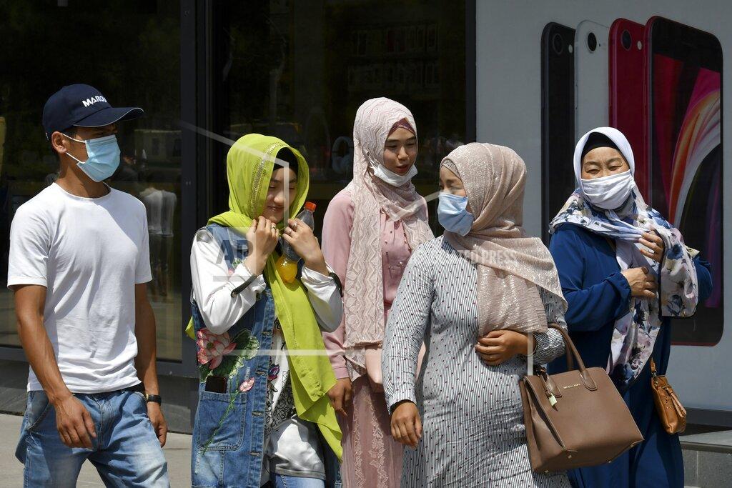 Vladimir Voronin People in face masks walk through a street in Bishkek, Kyrgyzstan, Friday, July 24, 2020. Coronavirus cases surged in Kyrgyzstan after authorities lifted a tight lockdown in May, overwhelming the health care system. But now thousands of volunteers are helping medical workers in busy hospitals, using cars into makeshift ambulances and finding protective gear, drugs, supplies and equipment. (AP Photo/Vladimir Voronin)