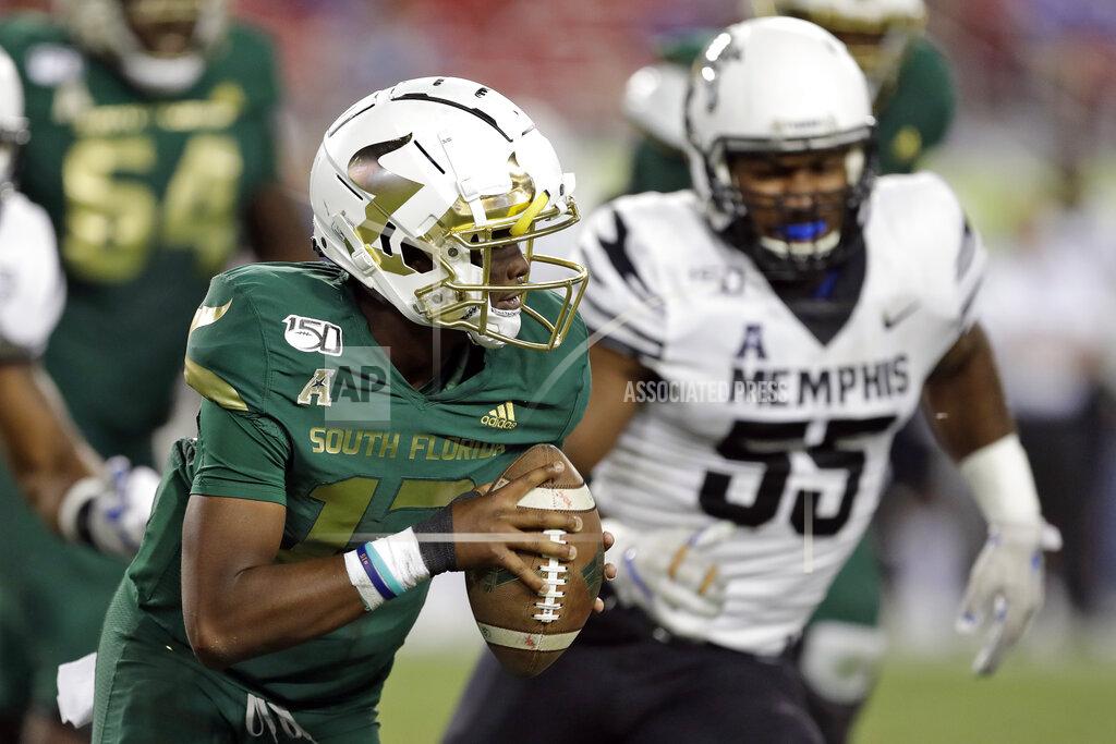 Chris O'meara South Florida quarterback Jordan McCloud (12) scrambles away from Memphis defensive end Bryce Huff (55) during the second half of an NCAA college football game Saturday, Nov. 23, 2019, in Tampa, Fla. (AP Photo/Chris O'Meara)