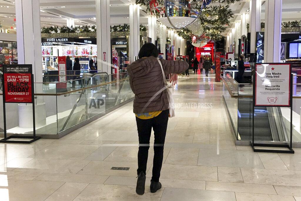 Anne D'innocenzio A shopper walks through Macy's flagship store at Herald Square an hour after its 6a.m. Black Friday opening, Friday, Nov. 27, 2020, in New York. (AP Photo/Anne D'Innocenzio)