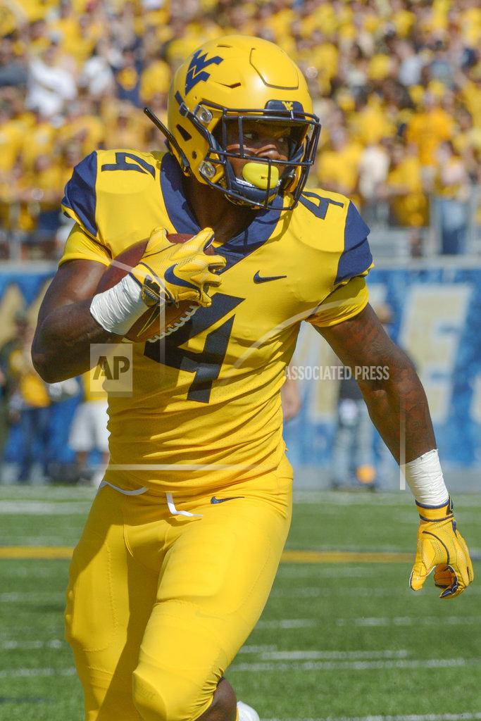 Craig Hudson West Virginia running back Leddie Brown (4) runs in for a touchdown during the first half of an NCAA college football game against Kansas in Morgantown, W. Va., Saturday Oct. 6, 2018. (Craig Hudson/Charleston Gazette-Mail via AP)