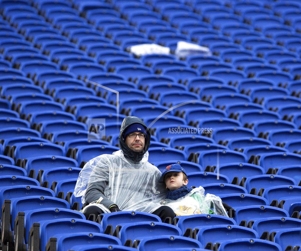 Ben Mckeown Two fans endure the cold and rain during an NCAA college football game between Duke and Wake Forest in Durham, N.C., Saturday, Nov. 24, 2018. (AP Photo/Ben McKeown)