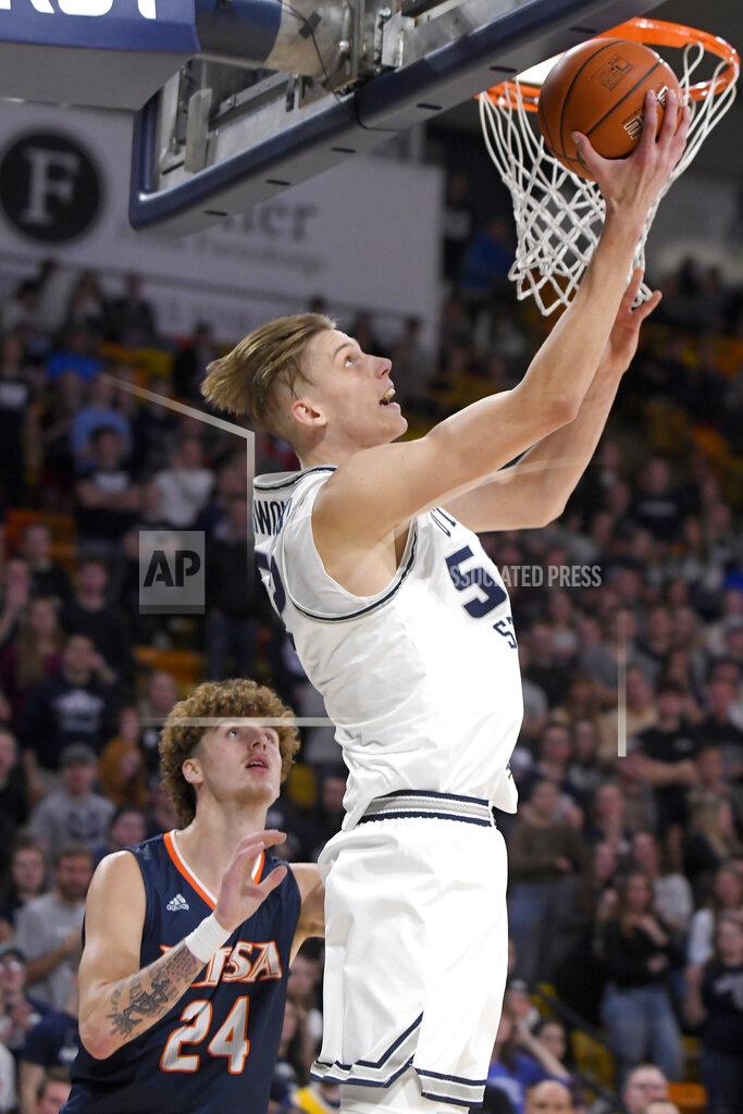 Eli Lucero Utah State center Kuba Karwowski takes a shot as UTSA center Jacob Germany (24) defends during the first half of an NCAA college basketball game Monday, Nov. 18, 2019, in Logan, Utah. (AP Photo/Eli Lucero)