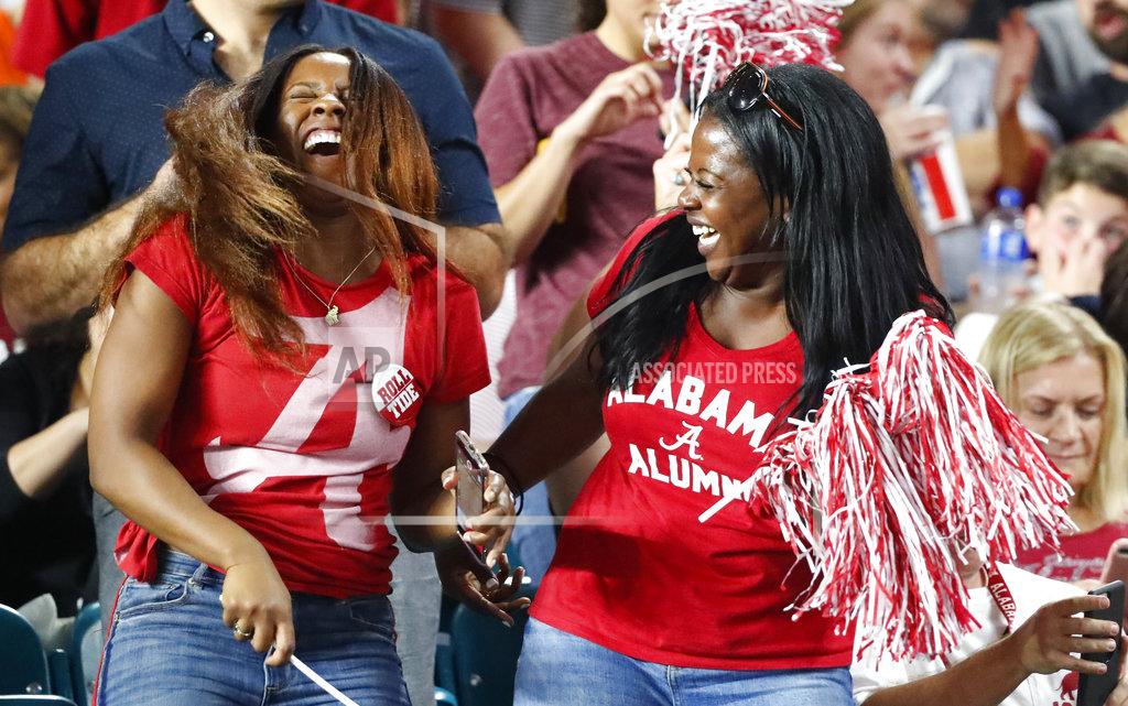 Wilfredo Lee Alabama fans celebrate, during the first half of the Orange Bowl NCAA college football game against Oklahoma , Saturday, Dec. 29, 2018, in Miami Gardens, Fla. (AP Photo/Wilfredo Lee)