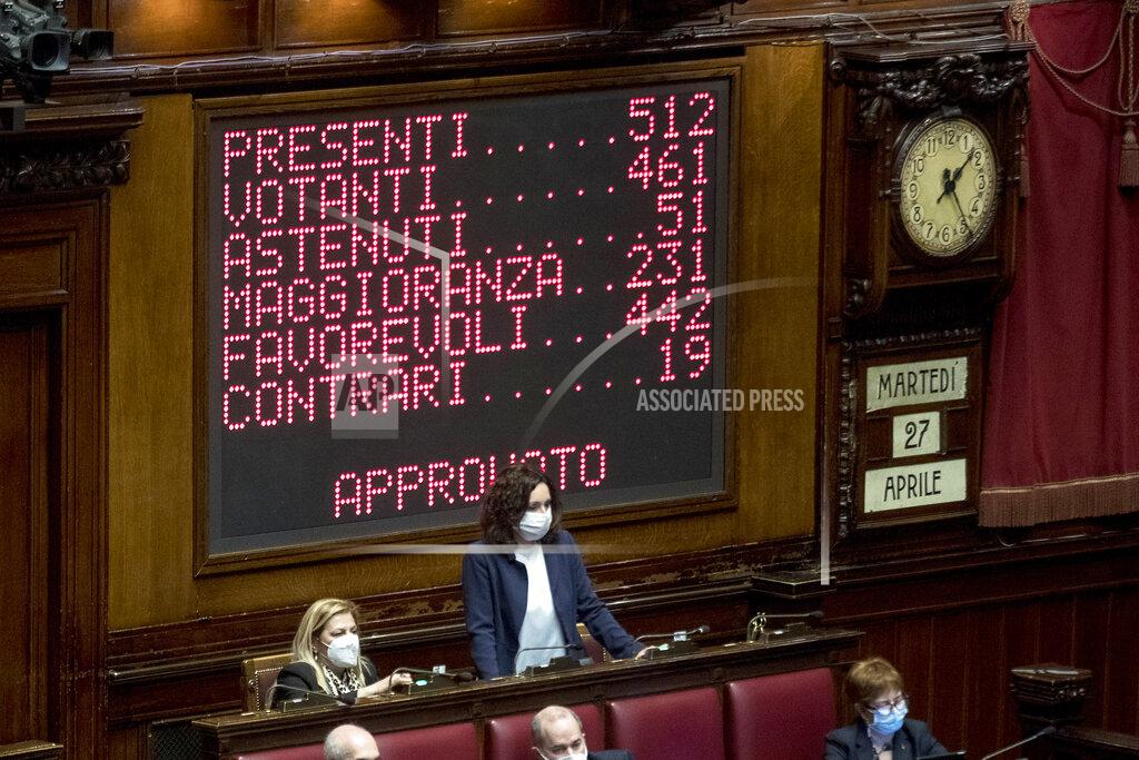 Roberto Monaldo A billboard shows the results of the lawmakers' vote on the Italian Premier Mario Draghi's coronavirus recovery plan, at the Chamber of Deputies, in Rome, Tuesday, April 27, 2021. Draghi is presenting a 222.1 billion euro ($268.6 billion) coronavirus recovery plan to Parliament, aiming to not only bounce back from the pandemic but enact “epochal” reforms to address structural problems that long predated COVID-19. Writing from top reads in Italian "Present 512, voting 461, did not vote 51, majority 231, in favor 442, contrary 19, Approved" (Roberto Monaldo/LaPresse via AP)