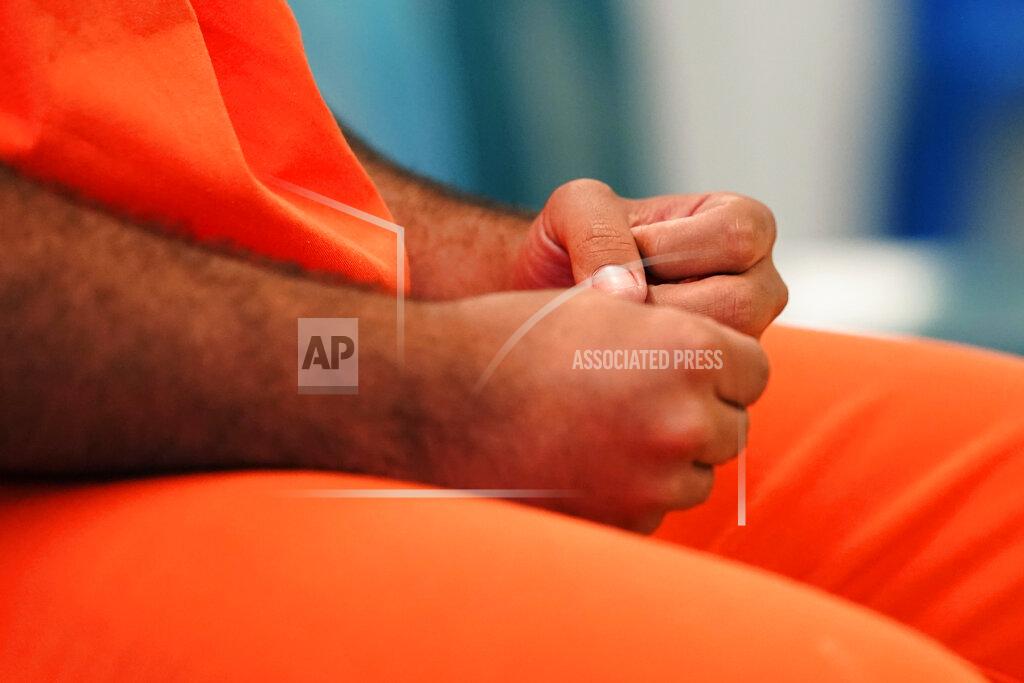 Gerald Herbert Immigration detainee Alexander Martinez gesticulates as he speaks during an interview with The Associated Press inside the Winn Correctional Center in Winnfield, La., Friday, July 30, 2021. (AP Photo/Gerald Herbert)
