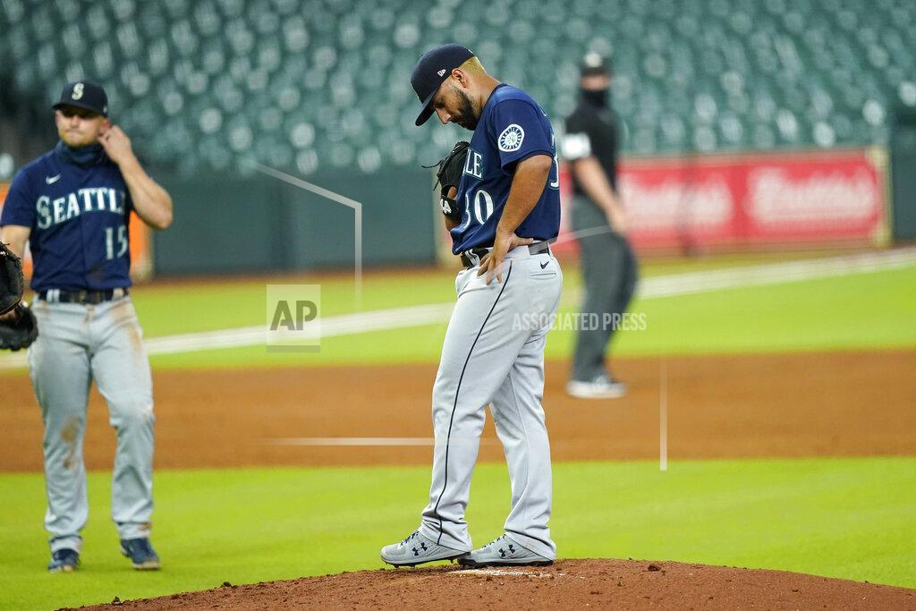 David J. Phillip Seattle Mariners starting pitcher Nestor Cortes (30) waits for manager Scott Servais to make his way to the mound to pull him during the first inning of a baseball game against the Houston Astros Friday, Aug. 14, 2020, in Houston. (AP Photo/David J. Phillip)