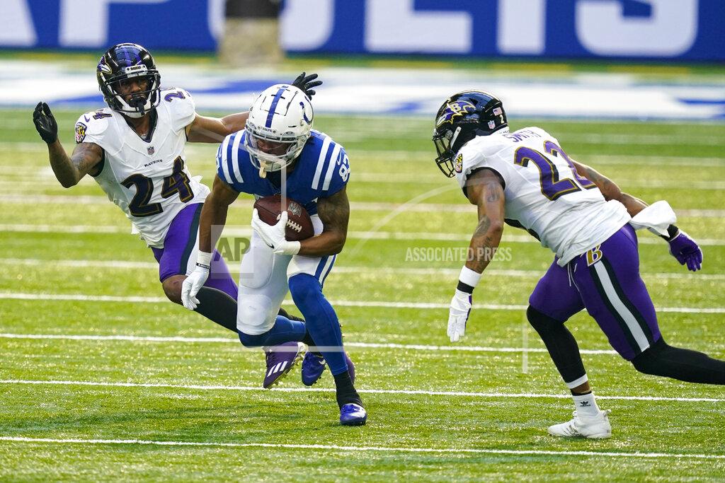 Darron Cummings Indianapolis Colts wide receiver Marcus Johnson (83) cuts between Baltimore Ravens cornerback Marcus Peters (24) and cornerback Jimmy Smith (22) after a catch in the first half of an NFL football game in Indianapolis, Sunday, Nov. 8, 2020. (AP Photo/Darron Cummings)