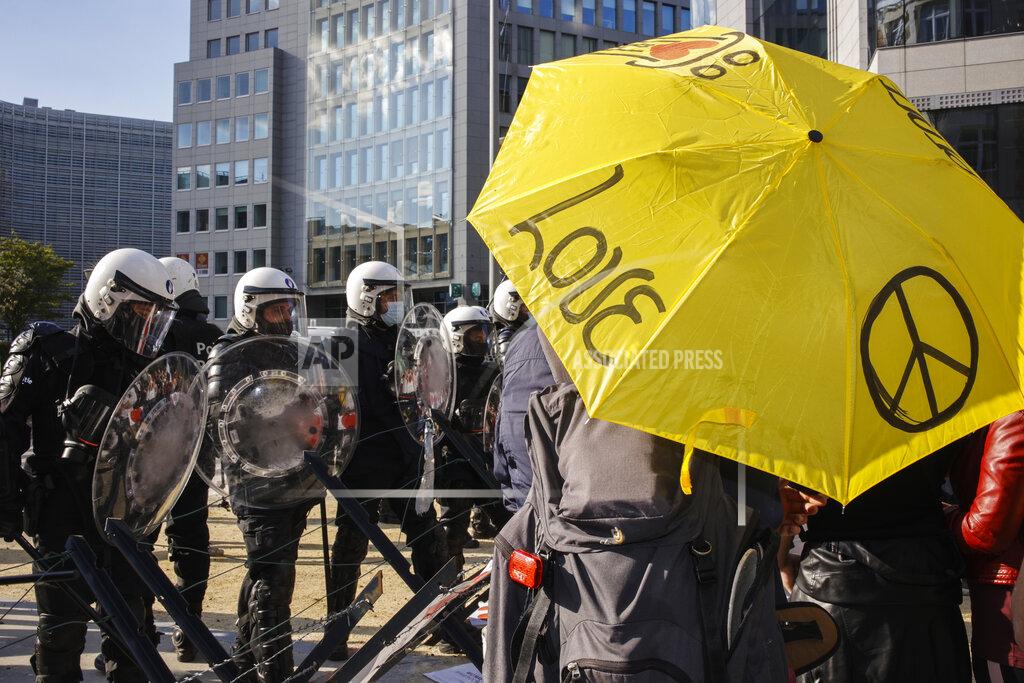Olivier Matthys People gather near EU headquarters during a so called "European Demonstration for Freedom and Democracy" protest against COVID-19 security measures taken by European governments, in Brussels, Saturday, May 29, 2021. (AP Photo/Olivier Matthys)