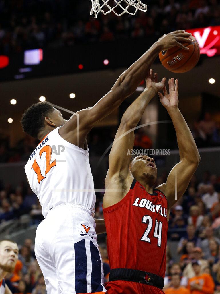 Steve Helber Virginia guard De'Andre Hunter (12) blocks the shot of Louisville forward Dwayne Sutton (24) during the first half of an NCAA college basketball game in Charlottesville, Va., Saturday, March 9, 2019. (AP Photo/Steve Helber)