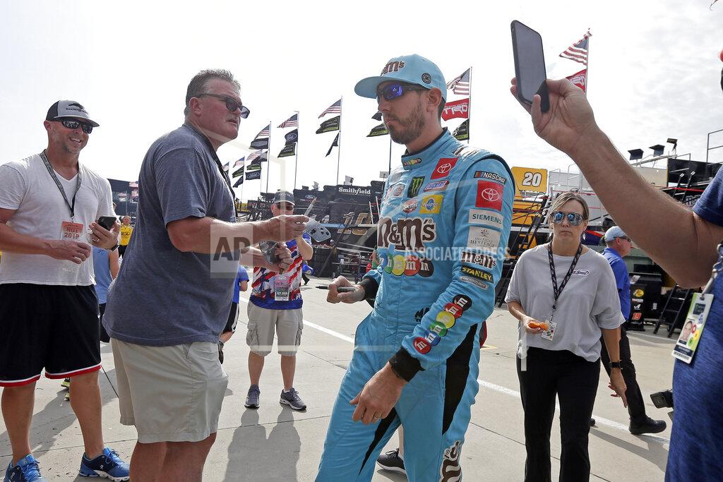 Gerry Broome Kyle Busch walks past fans seeking autographs during practice for Sunday's NASCAR Cup Series auto race at Charlotte Motor Speedway in Concord, N.C., Saturday, Sept. 28, 2019. (AP Photo/Gerry Broome)