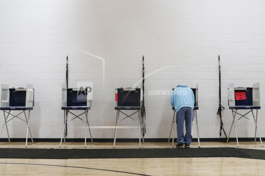 Tork Mason Carl Berg fills out his ballot during a special election for Wisconsin's 7th Congressional District on Tuesday, May 12, 2020, at Wausau East High School in Wausau, Wis. Republican Tom Tiffany and Democrat Tricia Zunker are vying to fill the vacancy left by Republican Sean Duffy, who resigned from the seat in September. (Tork Mason/The Post-Crescent via AP)