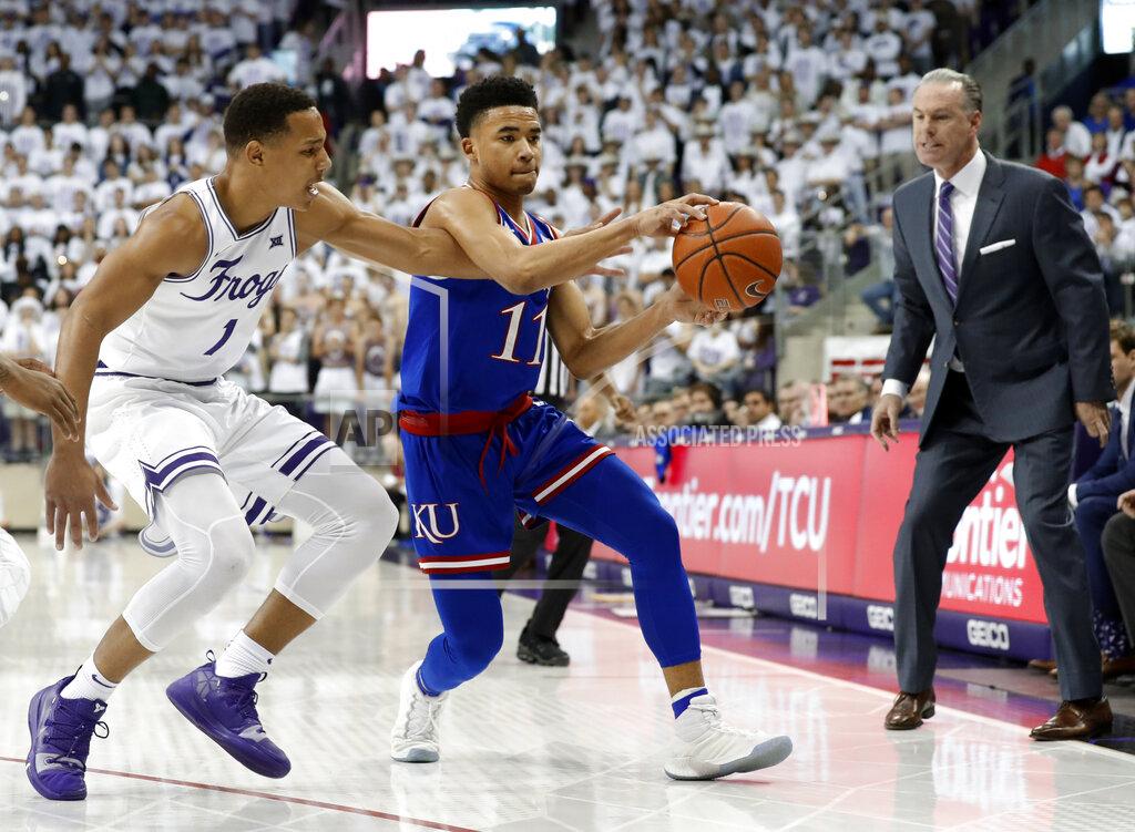 Tony Gutierrez TCU guard Desmond Bane (1) attempts to strip the ball away from Kansas guard Devon Dotson (11) as TCU head coach Jamie Dixon, right, watches in the first half of an NCAA college basketball game in Fort Worth, Texas, Monday, Feb. 11, 2019. (AP Photo/Tony Gutierrez)