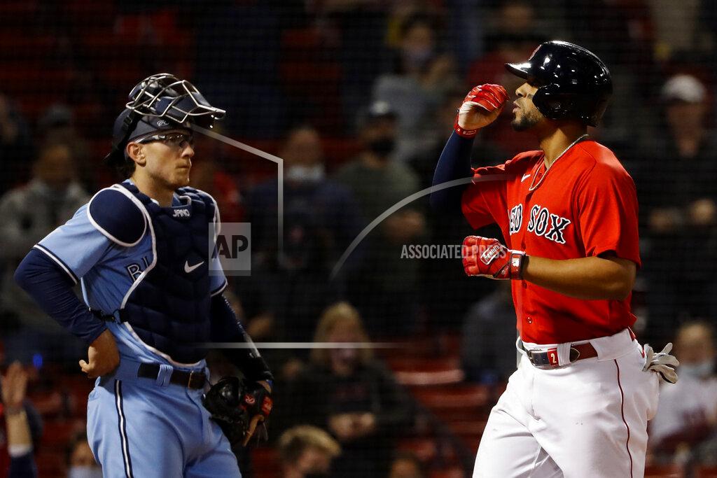 Winslow Townson As Toronto Blue Jays catcher Danny Jansen looks on, Boston Red Sox's Xander Bogaerts blows a kiss while crossing the plate after his three-run home run during the fourth inning of a baseball game Tuesday, April 20, 2021, at Fenway Park in Boston. (AP Photo/Winslow Townson)