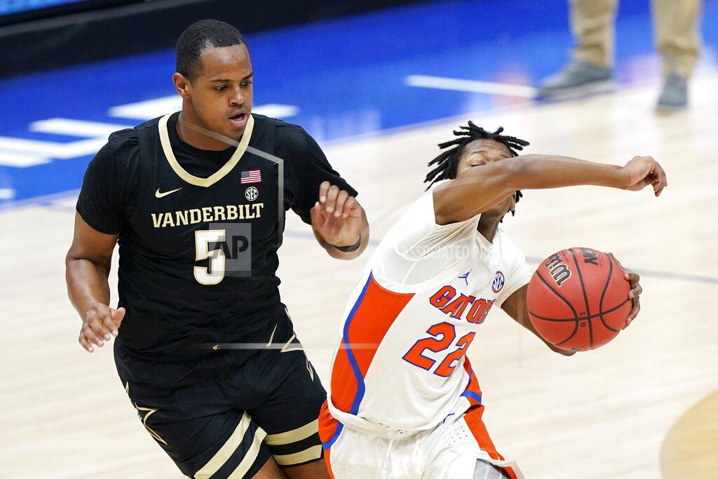 Mark Humphrey Florida's Tyree Appleby (22) drives against Vanderbilt's D.J. Harvey (5) in the first half of an NCAA college basketball game in the Southeastern Conference Tournament Thursday, March 11, 2021, in Nashville, Tenn. (AP Photo/Mark Humphrey)