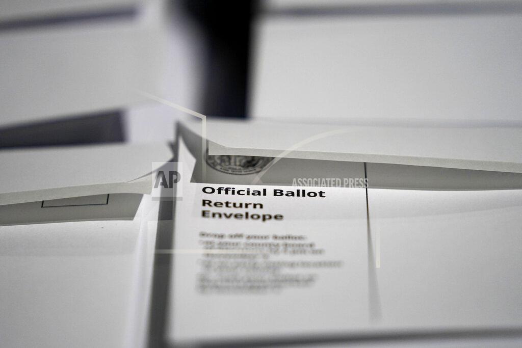 FILE - In this Sept. 3, 2020, file photo, stacks of ballot envelopes waiting to be mailed are seen at the Wake County Board of Elections in Raleigh, N.C. Black voters are among the least likely to vote by mail nationally, but there are early signs they are changing their behavior as the shadow of the coronavirus hangs over the presidential race. The evidence is clearest in North Carolina, the first state in the nation to send out mail ballots and where voting has been underway for almost three weeks. (AP Photo/Gerry Broome, File)