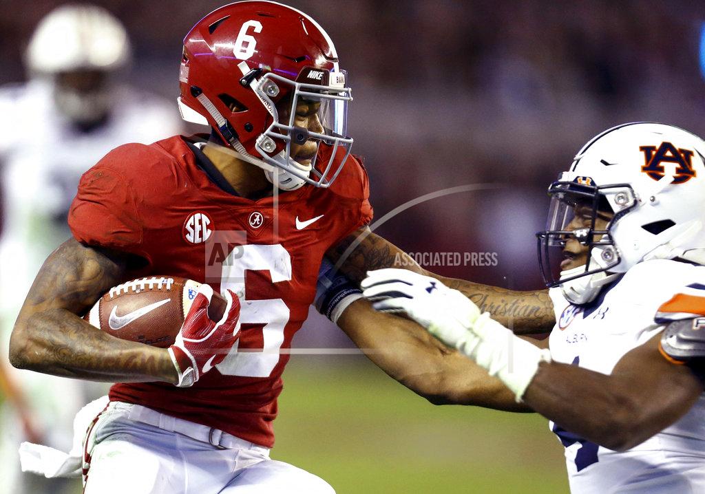 Butch Dill Alabama wide receiver DeVonta Smith (6) gets around Auburn defensive back Noah Igbinoghene (4) and scores a touchdown during the second half of an NCAA college football game, Saturday, Nov. 24, 2018, in Tuscaloosa, Ala. (AP Photo/Butch Dill)
