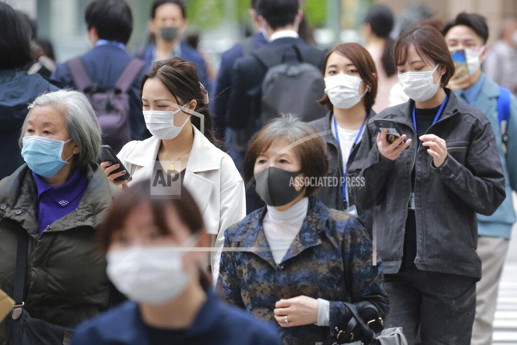 Koji Sasahara People wearing face masks to protect against the spread of the coronavirus walk on a street in Tokyo, Tuesday, April 13, 2021. (AP Photo/Koji Sasahara)