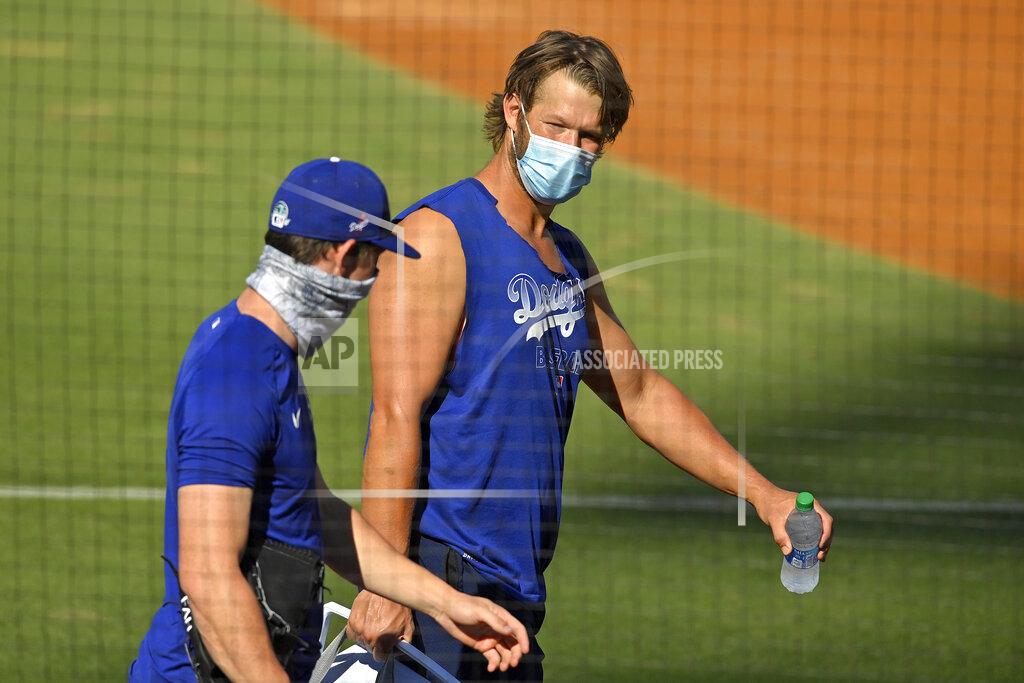 Mark J. Terrill Los Angeles Dodgers starting pitcher Clayton Kershaw, right, talks with starting pitcher Walker Buehler during the restart of baseball spring training Sunday, July 5, 2020, in Los Angeles. (AP Photo/Mark J. Terrill)