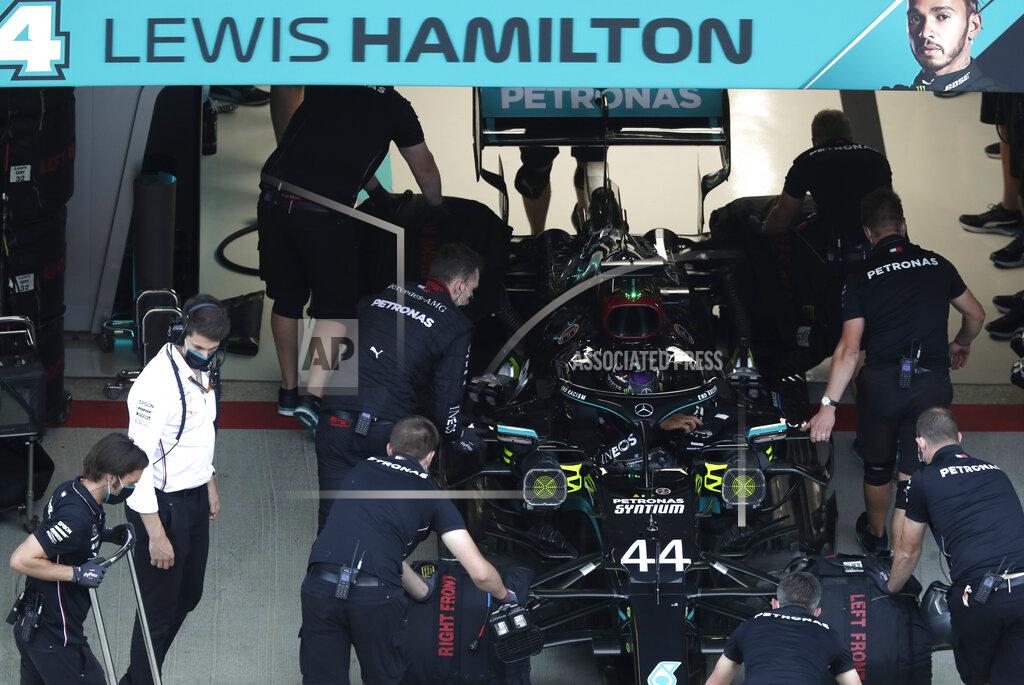 Pavel Golovkin Crew work on the car of Mercedes driver Lewis Hamilton of Britain during the qualifying session for the upcoming Russian Formula One Grand Prix, at the Sochi Autodrom circuit, in Sochi, Russia, Saturday, Sept. 26, 2020. The Russian Formula One Grand Prix will take place on Sunday. (AP Photo/Pavel Golovkin, Pool)