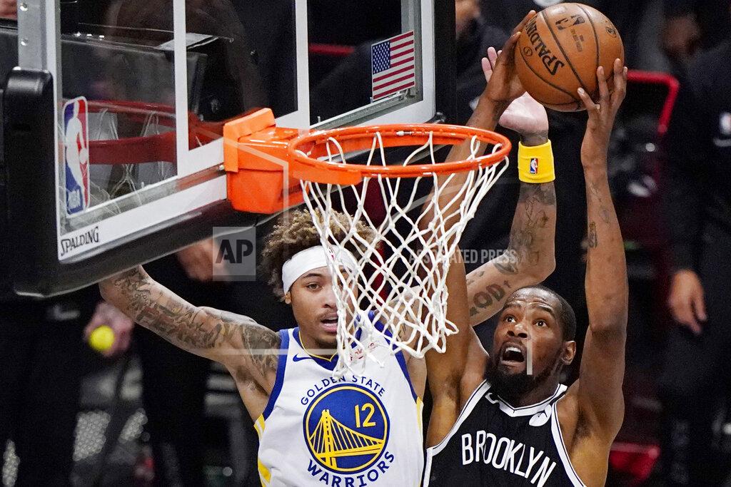 Kathy Willens Brooklyn Nets forward Kevin Durant (7) shoots as Golden State Warriors forward Kelly Oubre Jr., (12) defends during the first quarter of an opening night NBA basketball game, Tuesday, Dec. 22, 2020, in New York. (AP Photo/Kathy Willens)