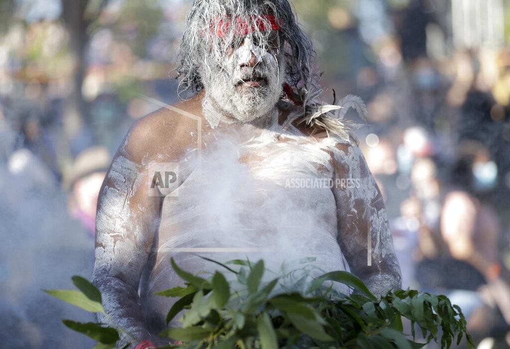 Rick Rycroft A member of the Koomurri Aboriginal Dancers participates in a smoking ceremony during Australia Day ceremonies in Sydney, Tuesday, Jan. 26, 2021. (AP Photo/Rick Rycroft)