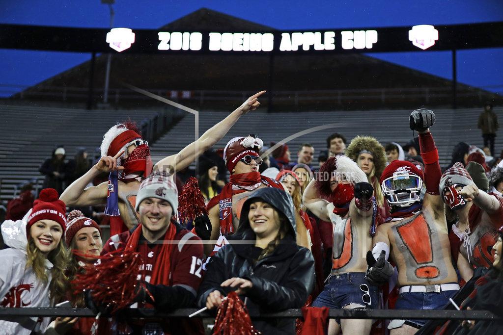 Ted S. Warren Washington State fans watch player warmups before the Apple Cup NCAA college football game against Washington, Friday, Nov. 23, 2018, in Pullman, Wash. (AP Photo/Ted S. Warren)