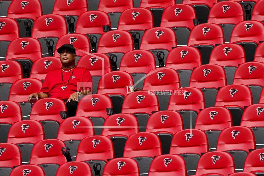 John Bazemore A fan watches play between the Atlanta Falcons and the Detroit Lions during the first half of an NFL football game, Sunday, Oct. 25, 2020, in Atlanta. (AP Photo/John Bazemore)