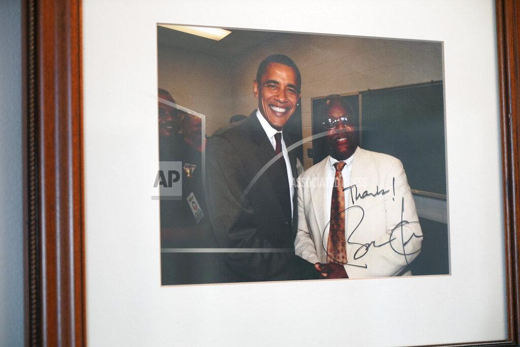Allen G. Breed A photograph of the late William Penn Troy Sr. with former President Barack Obama hangs on the wall of Troy's office in Mullins, S.C., on Sunday, May 23, 2021. Over the years, Troy, a funeral director, had served as a county commissioner, local school board member and church treasurer. But those were just his official duties. (AP Photo/Allen G. Breed)