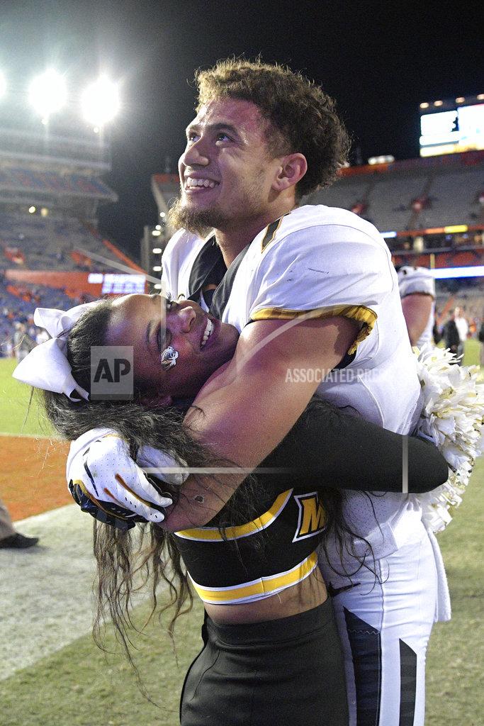 Phelan M. Ebenhack Missouri safety Cam Hilton (7) celebrates with a cheerleader after an NCAA college football game against Florida, Saturday, Nov. 3, 2018, in Gainesville, Fla. (AP Photo/Phelan M. Ebenhack)