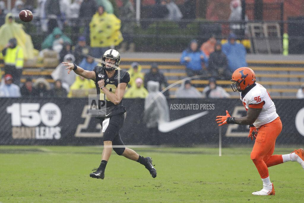 Darron Cummings Purdue quarterback Jack Plummer (13) throws while being chased by Illinois defensive lineman Tymir Oliver (96) during the first half of an NCAA college football game, Saturday, Oct. 26, 2019, in West Lafayette, Ind. (AP Photo/Darron Cummings)