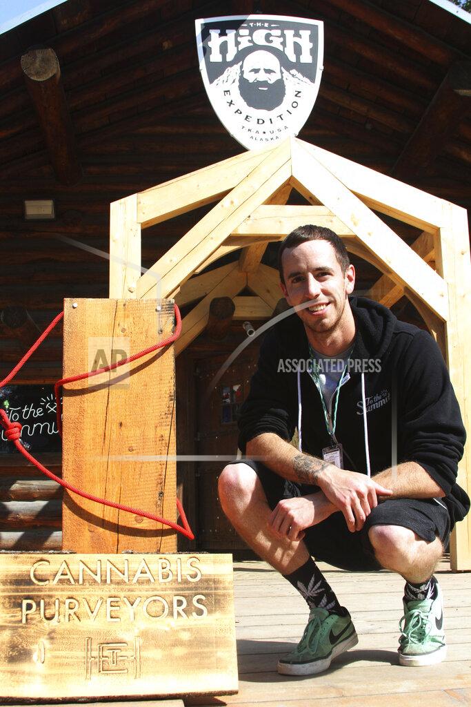 FILE - In this July 12, 2017, file photo, co-owner Joe McAneney poses for a photo in front of The High Expedition Co. in Talkeetna, Alaska. Regulators amid much fanfare in early 2020 approved the first cannabis lounges in Alaska. It was a milestone for the state's legal marijuana industry. Then the pandemic hit. An owner of one of the shops hopes to open later this year. An owner of the other said his shop opened briefly last fall before having to hit pause amid a surge in COVID-19 cases across the state. (AP Photo/Mark Thiessen, File)