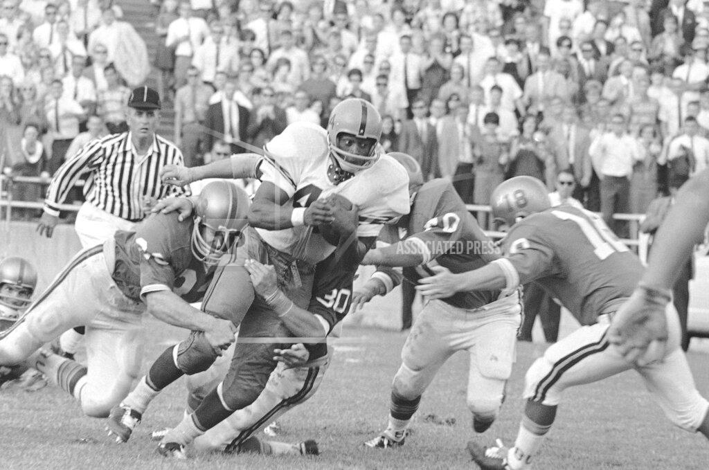 Fk FILE - In this Sept. 12, 1966 file photo, Syracuse's Floyd Little (44) runs down the field despite during a college football game at Baylor Stadium in Waco, Texas. Little, the Hall of Fame running back who starred at Syracuse and for the Denver Broncos, has died. The Pro Football Hall of Fame said he died Friday, Jan. 1, 2021. (AP Photo/FK, File)