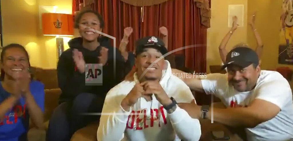 Uncredited In this still image from video provided by the NFL, Grant Delpit, center, gets congratulated as he's selected by the Cleveland Browns during the second round of the NFL football draft, Friday, April 24, 2020. (NFL via AP)