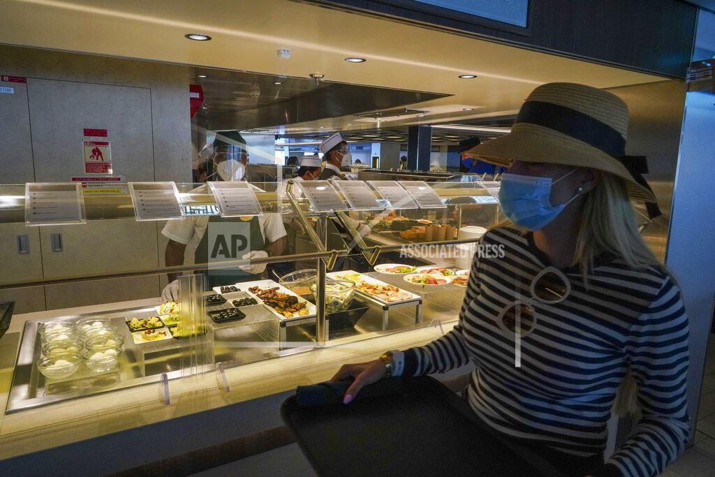 Andrew Medichini A passenger wears a face mask in a restaurant of the MSC Grandiosa cruise ship in Civitavecchia, near Rome, Wednesday, March 31, 2021. MSC Grandiosa, the world's only cruise ship to be operating at the moment, left from Genoa on March 30 and stopped in Civitavecchia near Rome to pick up more passengers and then sail toward Naples, Cagliari, and Malta to be back in Genoa on April 6. For most of the winter, the MSC Grandiosa has been a lonely flag-bearer of the global cruise industry stalled by the pandemic, plying the Mediterranean Sea with seven-night cruises along Italy’s western coast, its major islands and a stop in Malta. (AP Photo/Andrew Medichini)