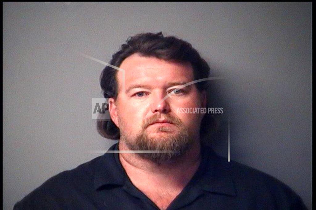 Uncredited CORRECTS CHARGES - In a photo provided by the Antrim County Sheriff, Michael Null is shown in a booking photo. Null is one of several charged Thursday, Oct. 8, 2020, in state court for allegedly seeking to storm the Michigan Capitol and seek a “civil war.” (Antrim County Sheriff via AP)